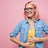 Happy caucasian woman having no problems with digestion holding hands on belly.