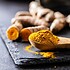 Indian turmeric powder and root. Turmeric spice. Ground turmeric.
