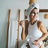 Smiling female doing skin care routine