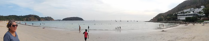 Charo looking at Naiharn beach with Mateo walking towards the beach pre lockdown