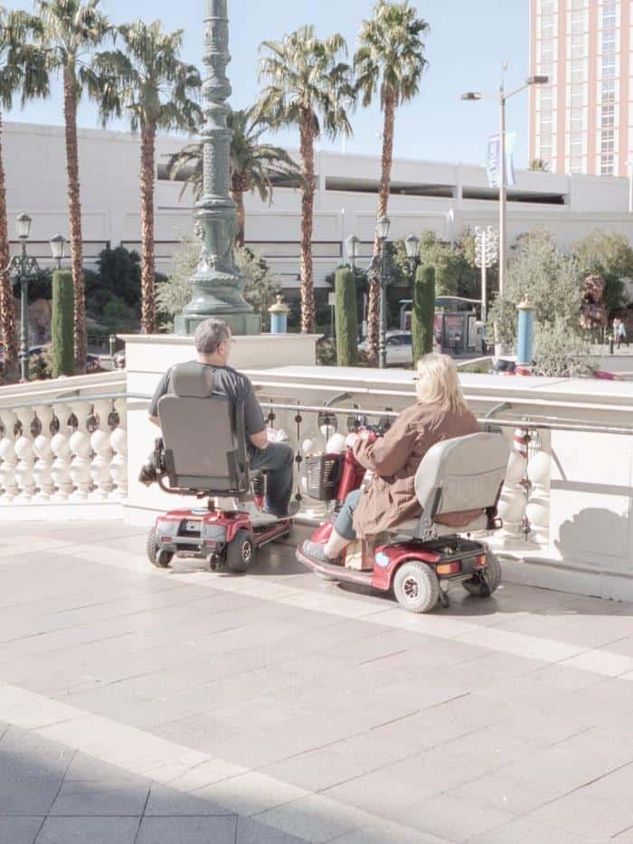 happy couple in electric wheelchairs