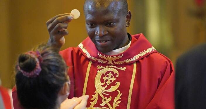 Maryknoll Father John Siyumbu distributes Communion during his ordination to the priesthood at the Maryknoll Society Center in Maryknoll, N.Y., June 3, 2022. Cardinal Luis Antonio Tagle, prefect of the Congregation for the Evangelization of Peoples, celebrated the ordination Mass. Father Siyumbu, who is from Bungoma, Kenya, is the first seminarian from East Africa to be ordained a Maryknoll priest. He will serve in Latin America. (OSV News photo/Gregory A. Shemitz)