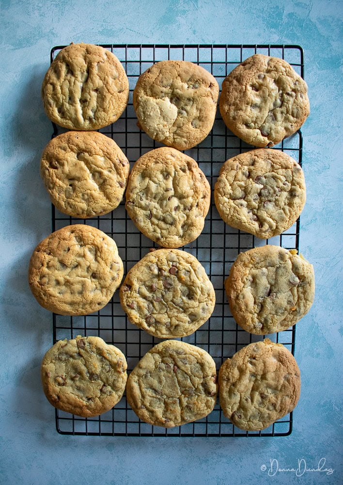 Cookies with chocolate chips cooling on wire rack