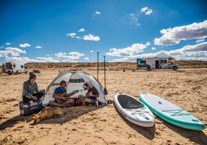 inflatable paddleboards on a beach that were inflated using electric pumps