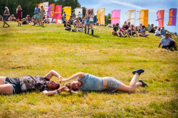 Girls rolling down the hill at Glastonbury 2015