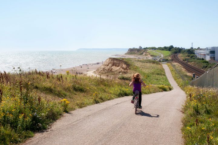 Girl freewheeling on a chopper on the coastal path to Bexhill