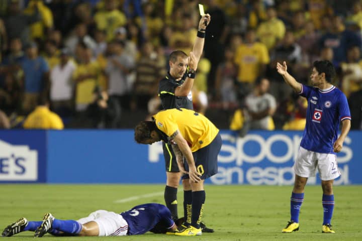 Matias Vuoso is issued a yellow card for an elbow that hit Horacio Cervantes while they were up in the air fighting for a header during the game e1630083942296 ○ Elbows, Arms, Shoulders (Are They Legal In Soccer) SOC: El Clasico Joven Club America vs. Cruz Azul
