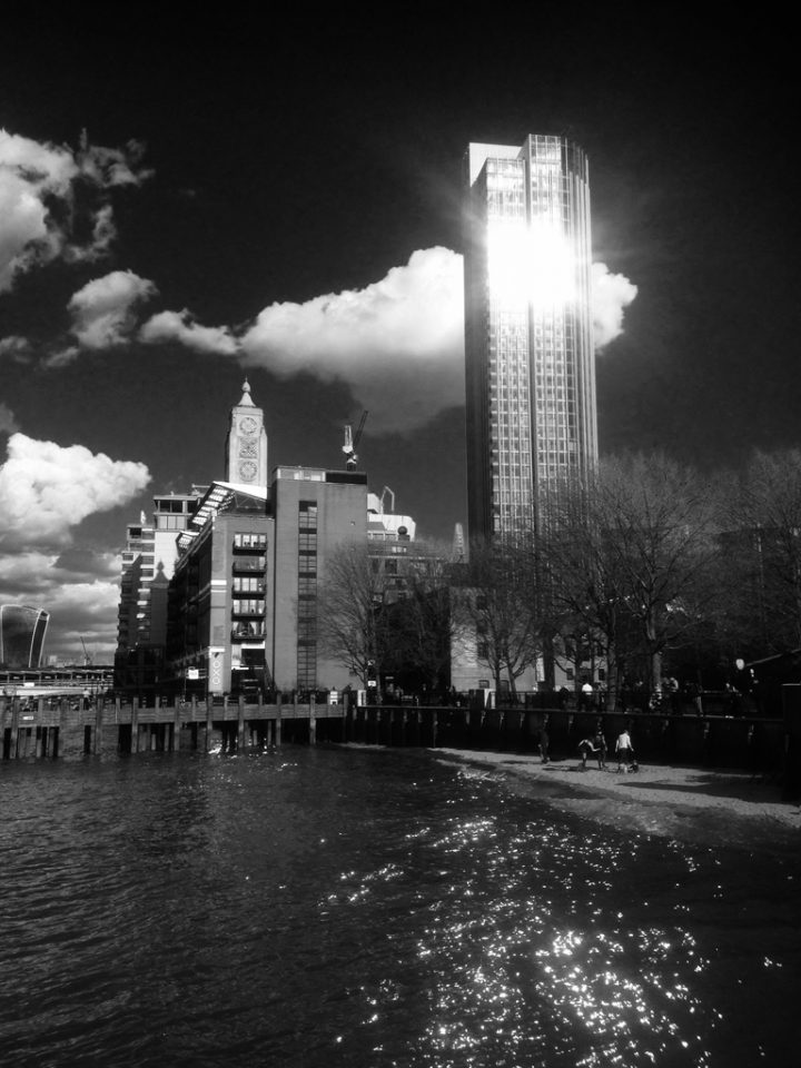 South Bank Tower with sun glare and a cloud