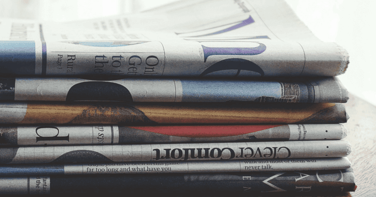 stack of newspapers replaced by social media blogs