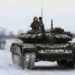Russian servicemen drive tanks during military exercises in the Leningrad Region, Russia on February 14, 2022.