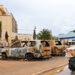 A street vendor pushes his cart past burned cars outside the headquarters of president Bazoum’s Nigerien Party for Democracy and Socialism in Niamey on August 7, 2023. (AFP)
