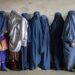 FILE - Afghan women wait to receive food rations distributed by a humanitarian aid group, in Kabul, Afghanistan, Tuesday, May 23, 2023. In a report issued on Monday, July 17, 2023, the U.N. says Taliban authorities have further increased restrictions on the rights of women and girls in Afghanistan in recent months. (AP Photo/Ebrahim Noroozi, File)