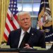 FILE PHOTO: U.S. President Donald Trump signs documents as he issues executive orders and pardons for Jan. 6 defendants in the Oval Office at the White House on Inauguration Day in Washington, U.S., January 20, 2025. REUTERS/Carlos Barria/File Photo