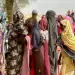 People who fled the Zamzam camp wait for food rations in a makeshift encampment. (AFP/Getty Images)
