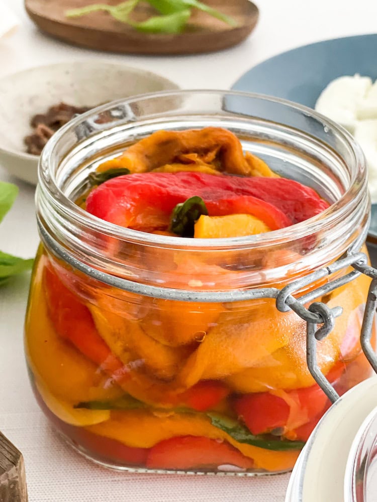 roasted pepper jar with ingredients in far background