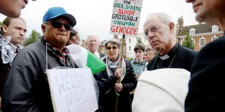 The Archbishop of Canterbury with Palestinian protestors outside Gloucester Cathedral in May 2024 Credit: PAUL NICHOLLS