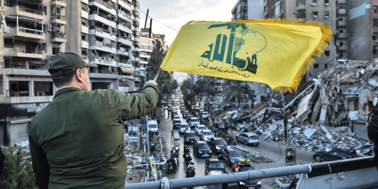 A man waves a Hezbollah flag on Wednesday as people try to return to their houses after the ceasefire agreement with Israel came into force. Photograph: Fadel Itani/UPI/Rex/Shutterstock