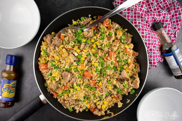 fried rice with leftover roast pork in frying pan.