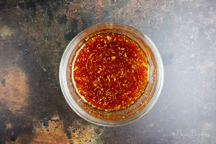 olive oil, paprika, oregano and cumin in small glass dish.