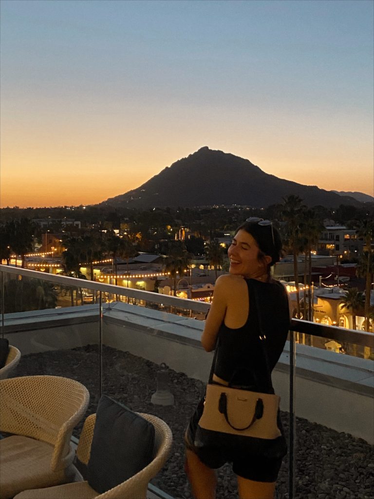 girl watching sunset over outrider rooftop lounge in scottsdale arizona