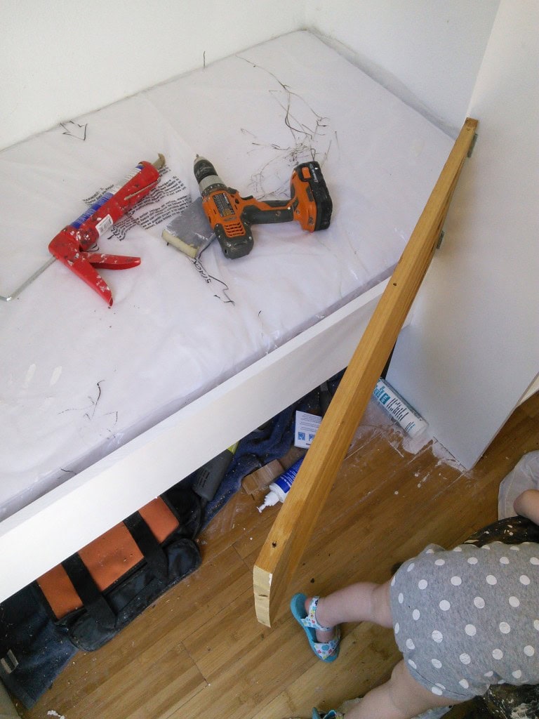 The bottom rail is on hinges so it can open and close, its really not that far of a fall but Hazel is a bit of a sleep walker/crawler so I wanted a rail,  she is learnign how to open and close it.  The idea is not that she is trapped but th :)at she is safe.