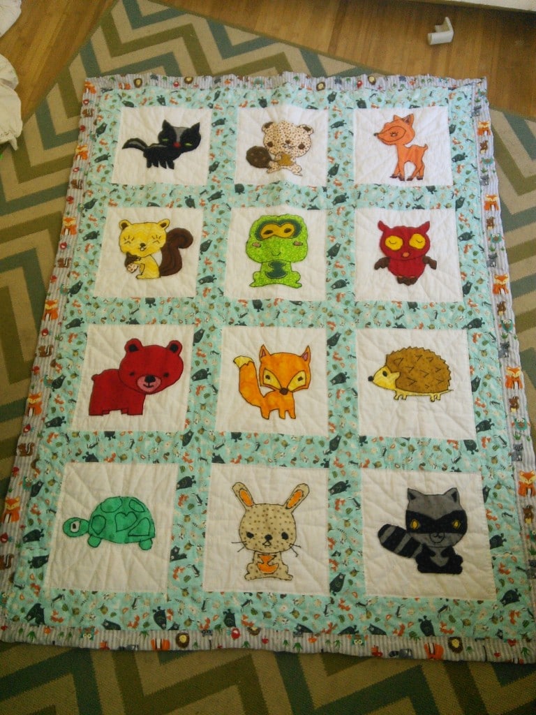 THIS is the finished quilt that mom made for Mr. T(iny), he got woodland creatures!