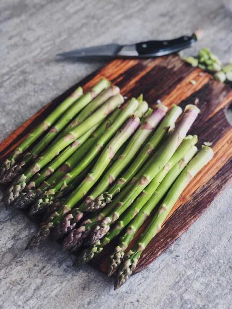 How to cook asparagus - asparagus trimmed on a cutting board