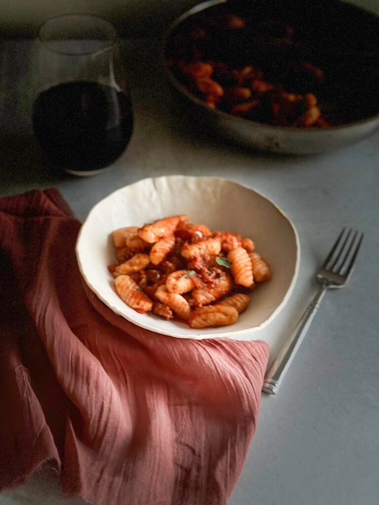 lifestyle pics with red napkin and a bowl of handmade cavatlli