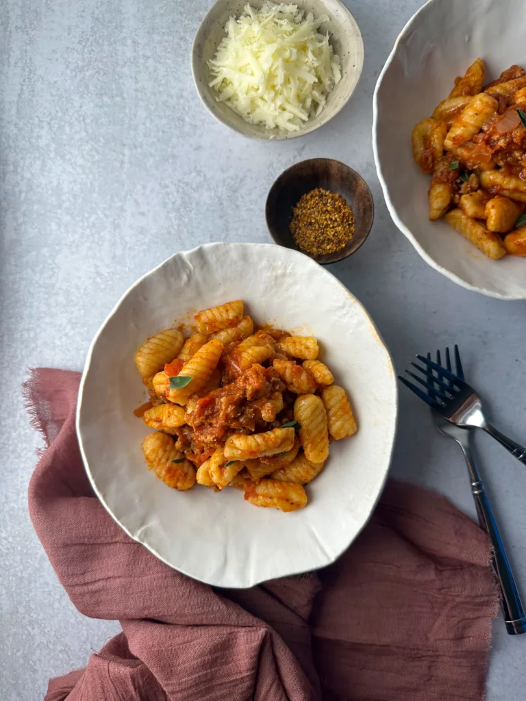 2 plates of cavatelli with spicy sausage
