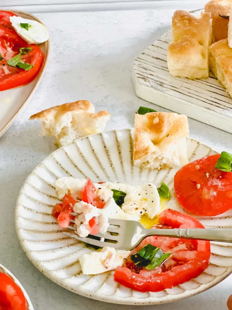 fork on a plate of Caprese Salad