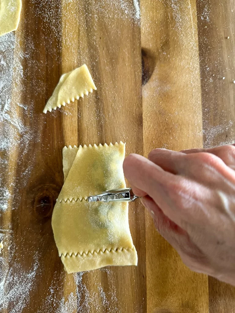 Using a ravioli cutter to cut the ravioli