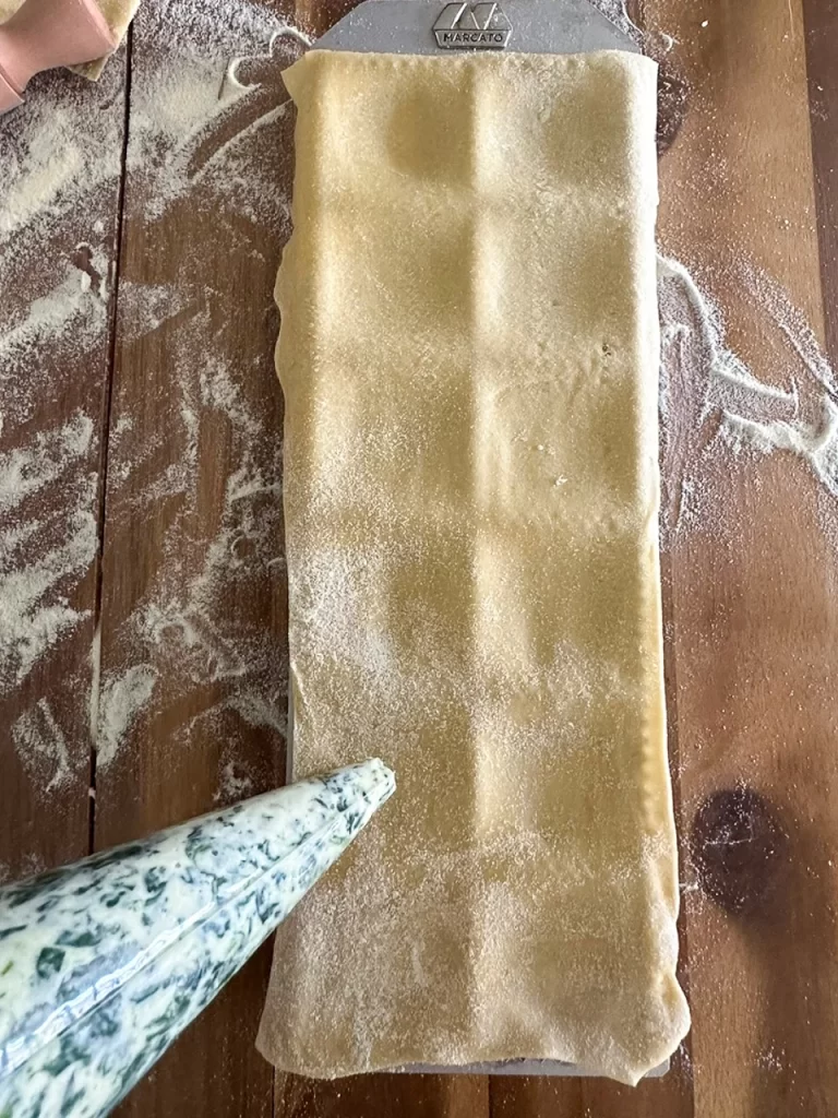 Filling the ravioli with a pastry pipe