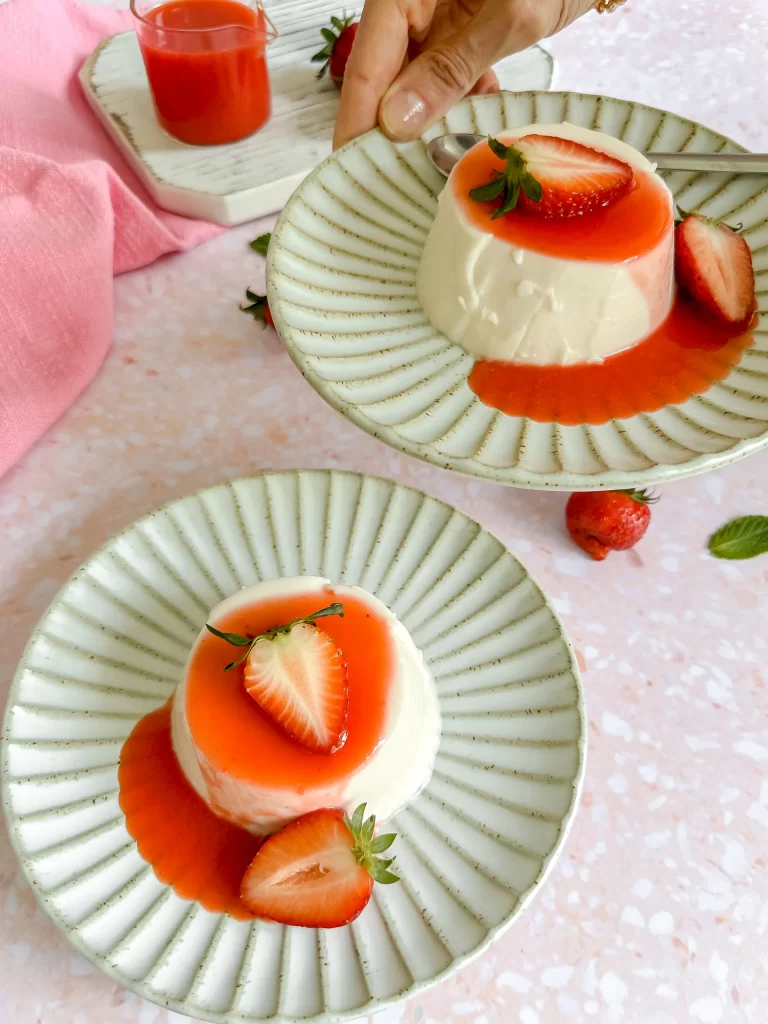 Handing a plate of panna cotta with kefir and strawberry