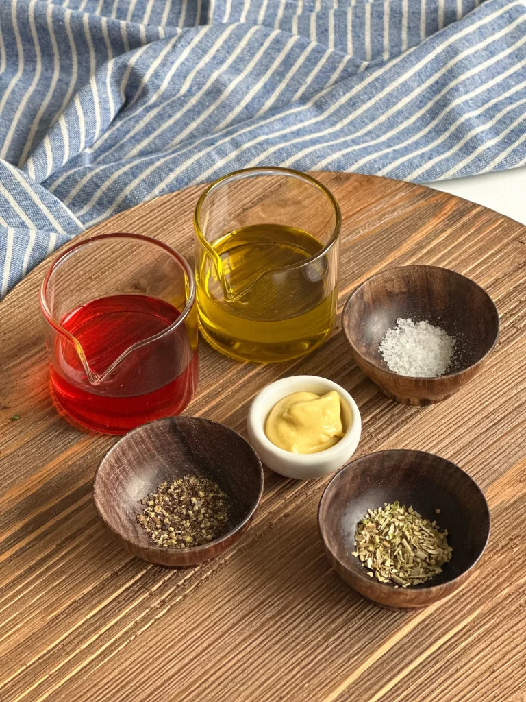 Italian potato salad dressing ingredients on a wood board