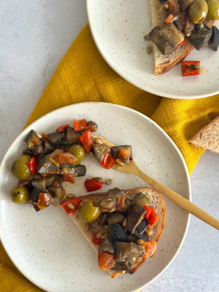 Caponata in a plate and over bruschetta