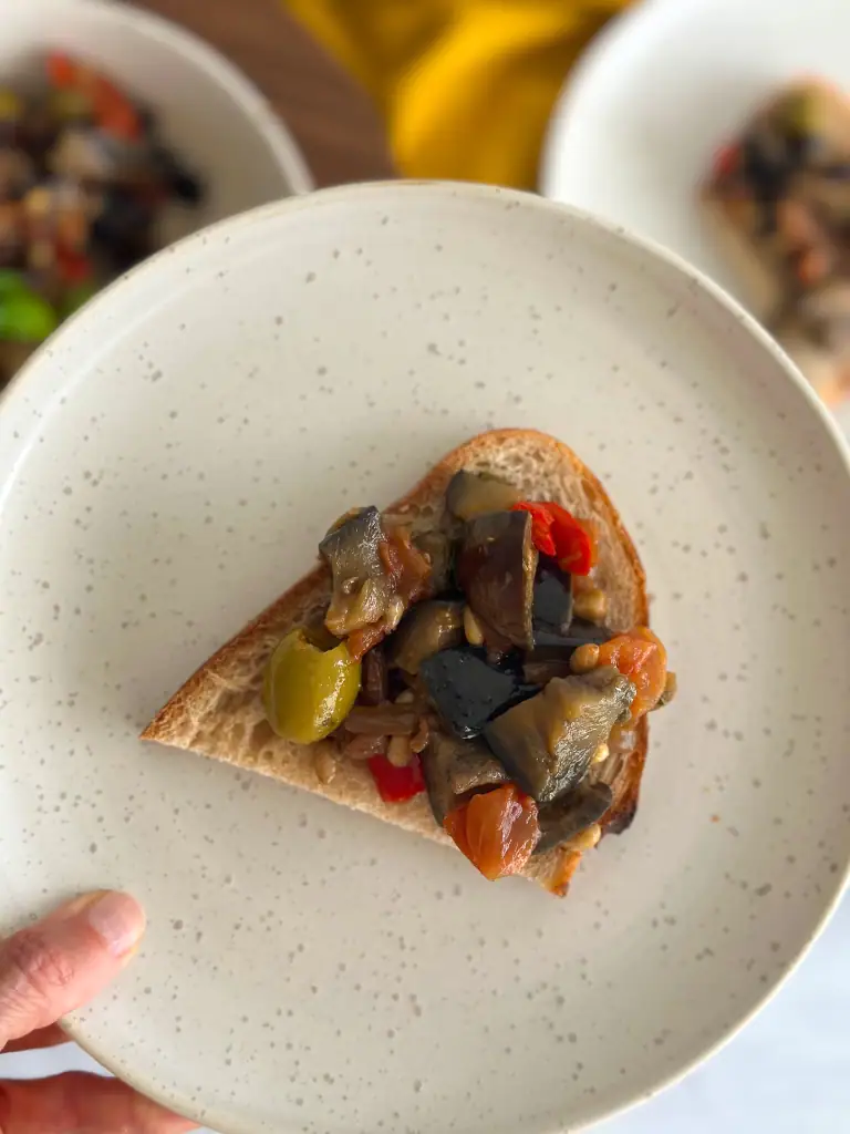Plate in hand with caponata