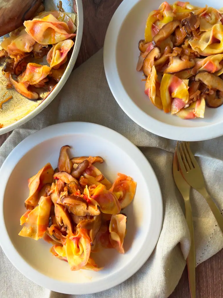 Sorpresine pasta with mushroom sauce in 2 white plates