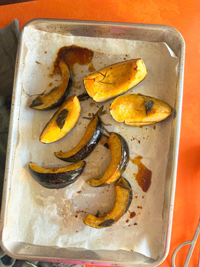 maple and sage baked acorn squash on baking tray