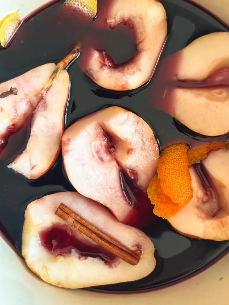 Close up of pears in a pot with red wine