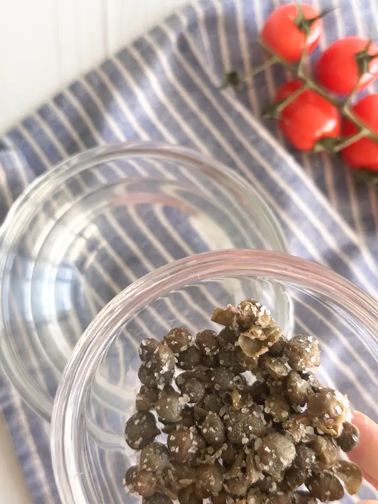 Capers packed in salt need to be rinsed. The most important ingredient of Insalata Pantesca