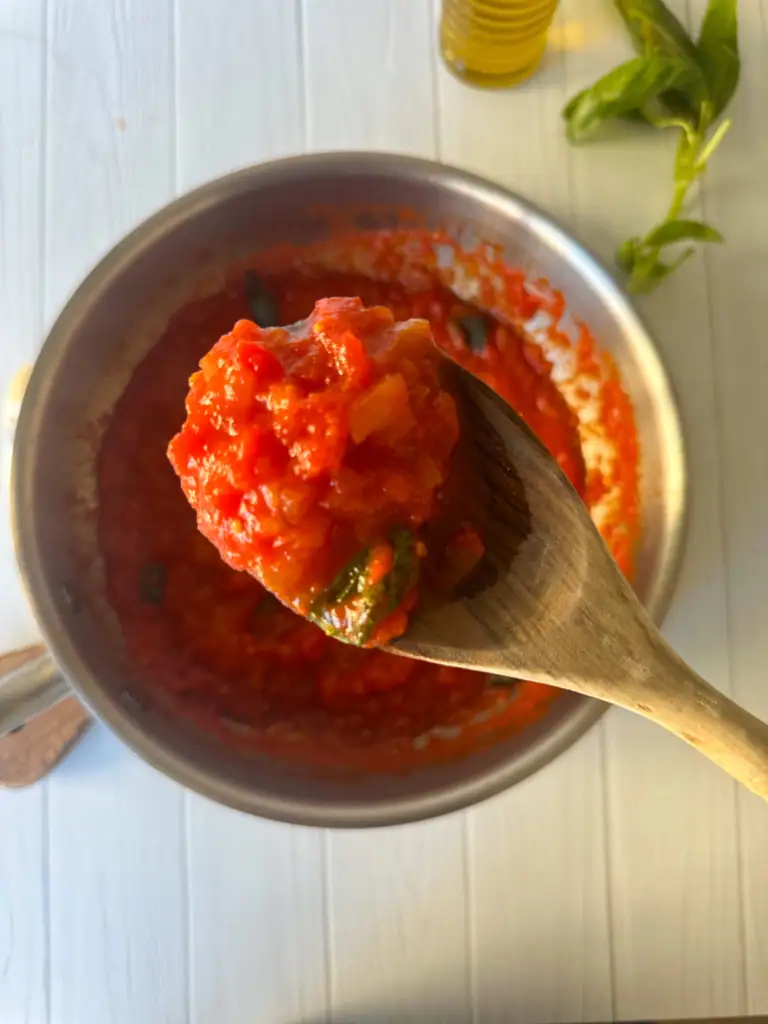 Tomato sauce on a wood spoon