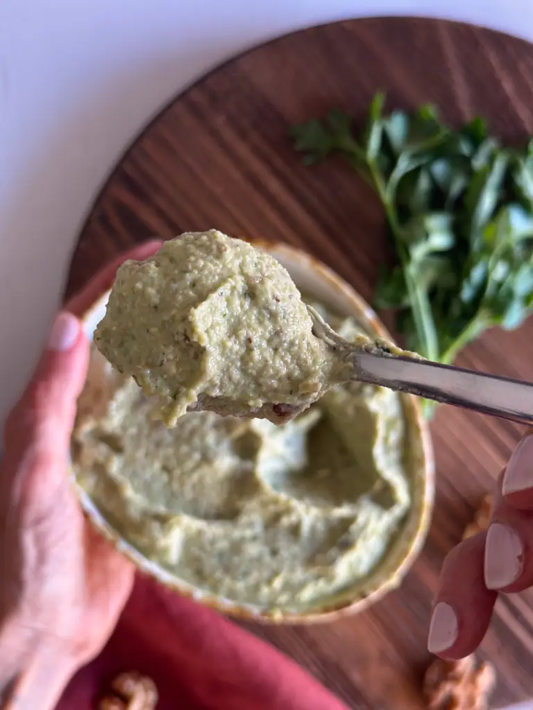 Walnut sauce in a bowl in hand