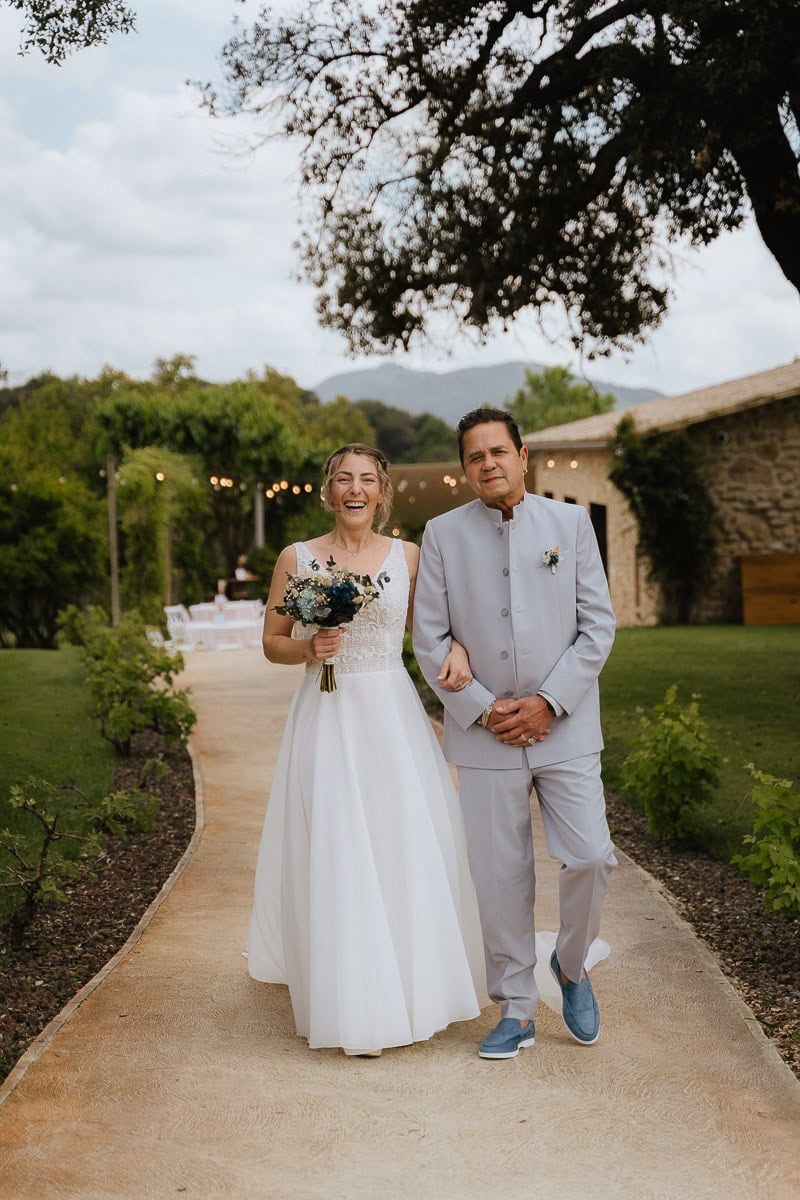 Bride with her father walking towards the wedding ceremony at finca wedding venue