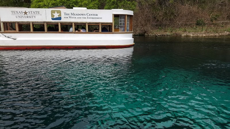 The Texas State University Glass Bottom Boat Tour floating through Spring Lake