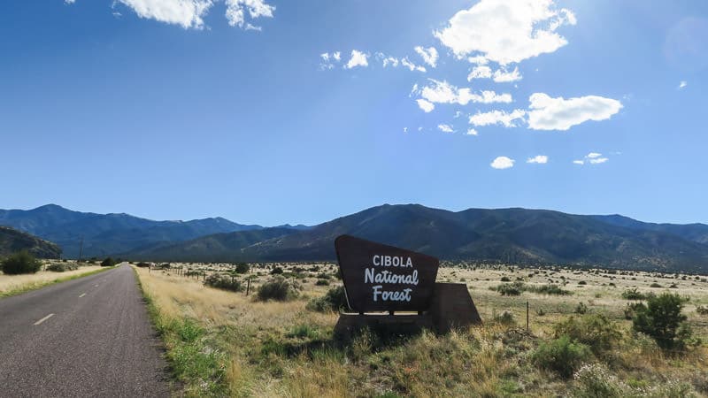 cibola forest sign with mountains and fields