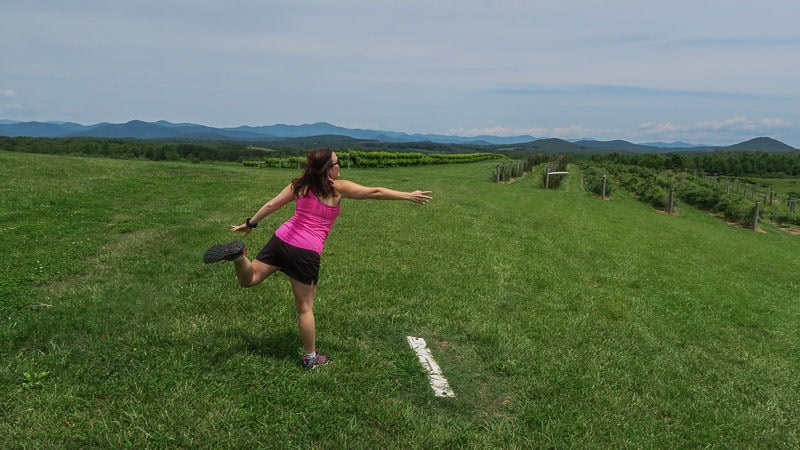 Brooke throwing her first disc at the disc golf course at Chattooga Belle Farm