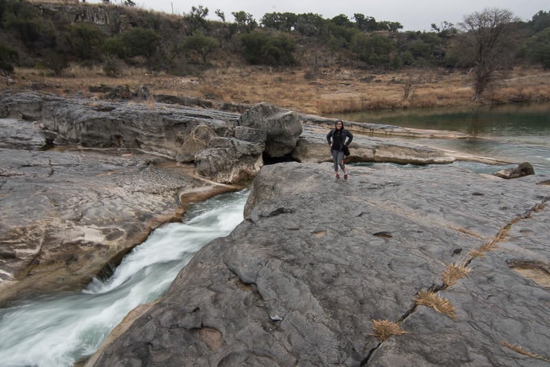 Brooke posing next to the flowing water of the Pedernales River