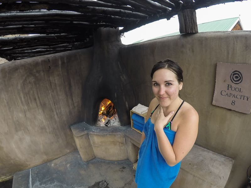 Brooke wrapped in a towel by the fireplace in our private pool