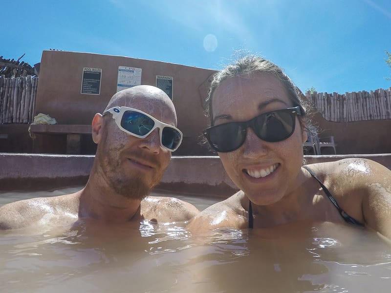 Brooke and Buddy soaking in the mud pool at Ojo Caliente