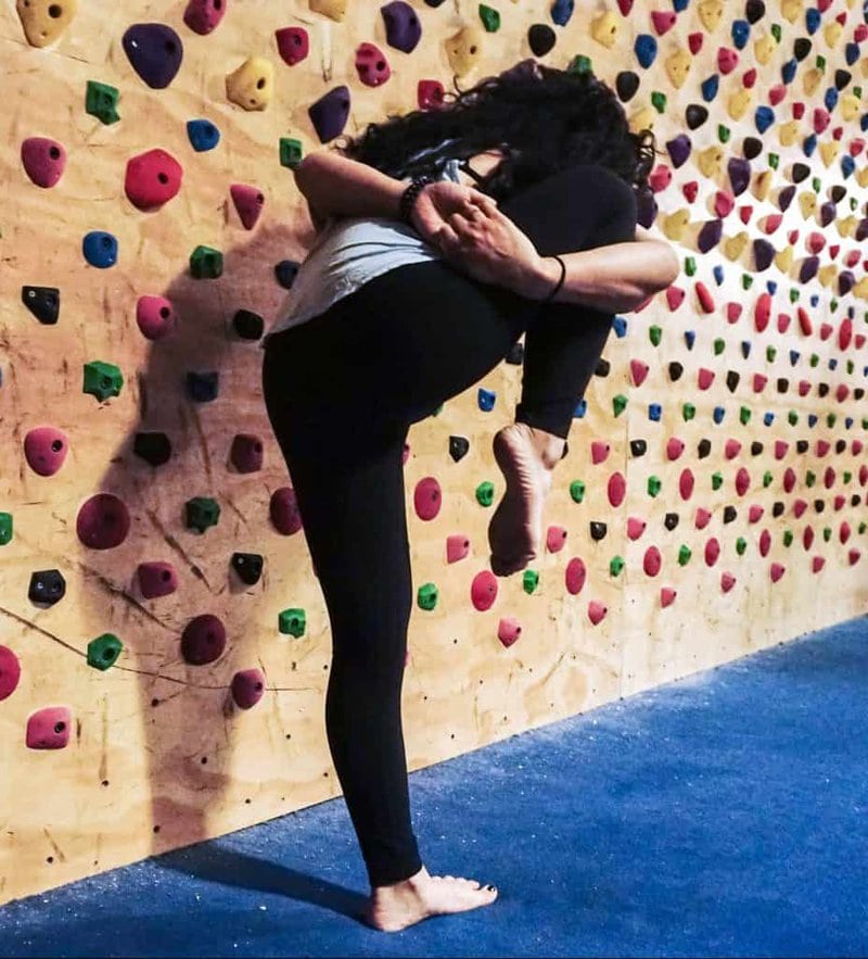 A yoga instructor demonstrates a pose.